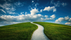 Green land with pathway and blue sky with clouds